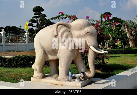 Samut Prakan, Thailand: Statue of a revered Thai elephant complete with two plastic bottles of water left as offerings Stock Photo