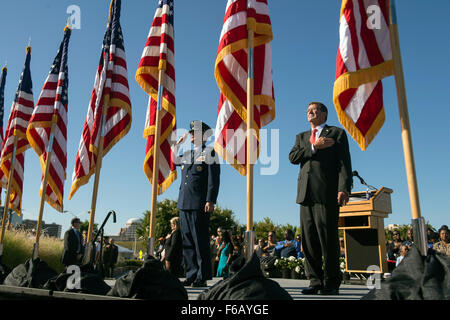 Defense Secretary Ash Carter and Air Force Gen. Paul Selva, vice chairman of the Joint Chiefs of Staff,render honors as the national anthem is played during a remembrance ceremony Sept. 11, 2015, at the Pentagon Memorial to honor the memory of those killed in the 9/11 terrorist attack. The ceremony was attended by family members who lost loved ones. (DoD photo by Senior Master Sgt. Adrian Cadiz)(Released) Stock Photo
