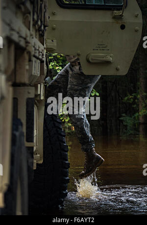 Flood water from the Edisto River quickly rose during high tide, while South Carolina National Guard Soldiers helped residents protect their property Oct. 9, 2015 in Parkers Ferry, S.C. The historic flooding, which has caused damage, destruction and death throughout South Carolina, has been the result of record-setting rainfall during what is being considered a 1,000-year event delivered by Hurricane Joaquin as it traveled up the East Coast. (U.S. Air Force photo by Staff Sgt. Perry Aston/Released) Stock Photo