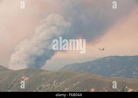 A CH-47 Chinook helicopter from the 1-126th Aviation Regiment prepares to approach for a water drop during the Rocky Fire near Clearlake, Calif., Aug. 1. (U.S. Army National Guard photo by Sgt. Jason Beal/Released) Stock Photo