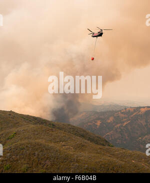 A California Army National Guard CH-47 Chinook helicopter prepares to approach for a water drop during the Rocky Fire near Clearlake, Calif., Aug. 1. (U.S. Army National Guard photo/ Sgt. Jason Beal/ released) Stock Photo