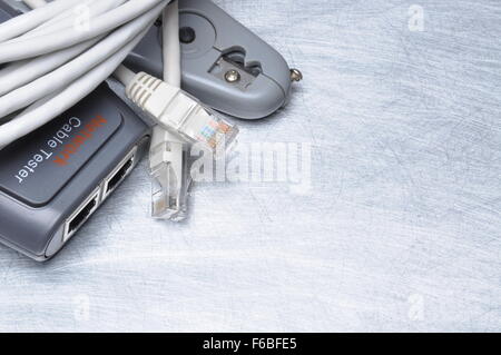 Network tester and crimping tool with RJ45 connector on metal background with place for text Stock Photo