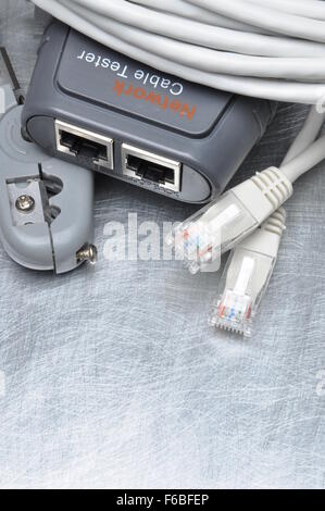 Network tester and crimping tool with RJ45 connector on metal background with place for text Stock Photo