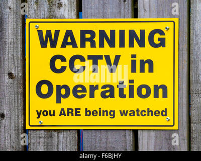 Notice warning of the presence of CCTV surveillance cameras Warning CCTV in operation you are being watched Stock Photo