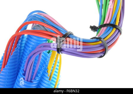 Colored electrical copper cables for electrician in corrugated pipe isolated over white background Stock Photo