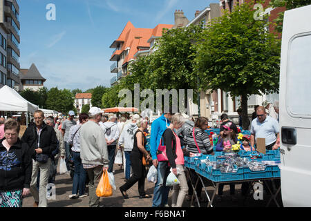 A busy street market in the Belgian coastal town of De Panne on a warm sunny day. Stock Photo