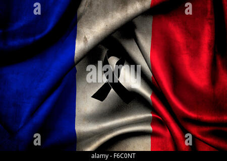 French flag with a black ribbon in commemoration of the victims of terrorist attack in Paris 13 November 2015 Stock Photo