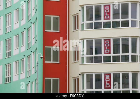 A large apartment or block of flats currenlty empty but with signs in a lot of the windows indicating that the individual flats Stock Photo