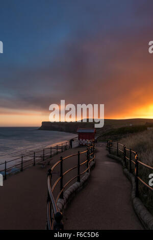 Enjoying the sunrise and reflections over the North Sea at Saltburn-by-the-Sea, Cleveland, North Yorkshire, England Stock Photo