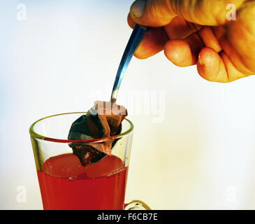 raspberry,herb,tea, flavoured ,beveridge,drink,sweet,hand,glass,cup,spoon,bag, Stock Photo