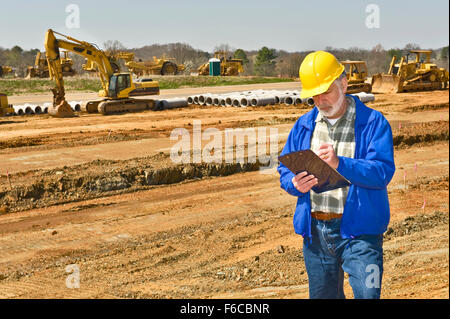 Foreman Keeping Records on Highway Construction Site Stock Photo