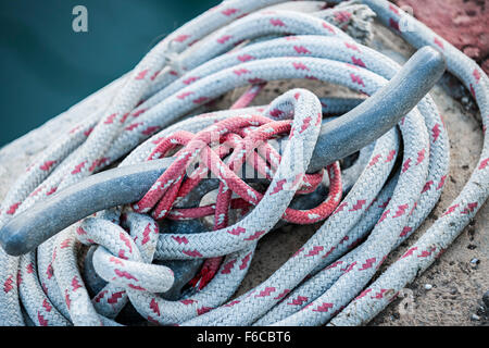 Nautical ropes tied around horn cleat on dock, close up.  Key West harbor, Florida. Stock Photo