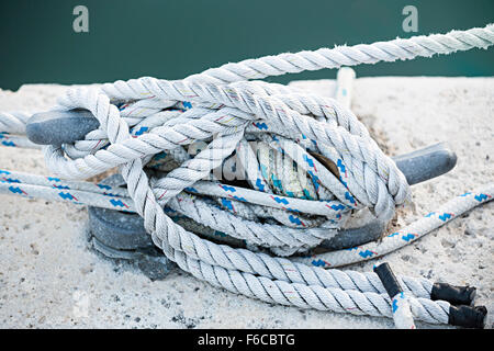 Nautical ropes tied around horn cleat on dock, close up.  Key West harbor, Florida. Stock Photo