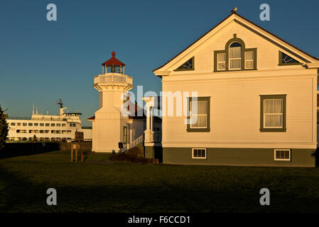 WASHINGTON - Sunset color turning the Mukilteo Light Station a deep yellow, located next to the Mukilteo to Clinton ferry dock. Stock Photo