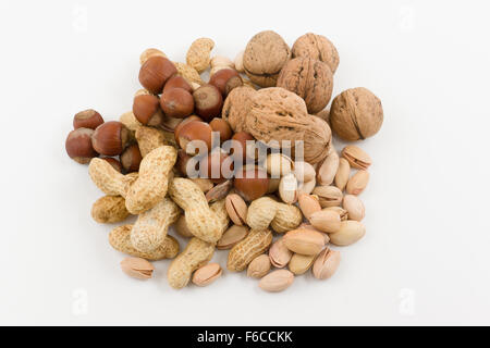 mix from various nuts lies a hill on a white background Stock Photo