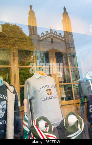 Clothes for sale at Ryder and Amies Club Outfitters and University clothes shop window Cambridge UK with Kings College chapel re Stock Photo