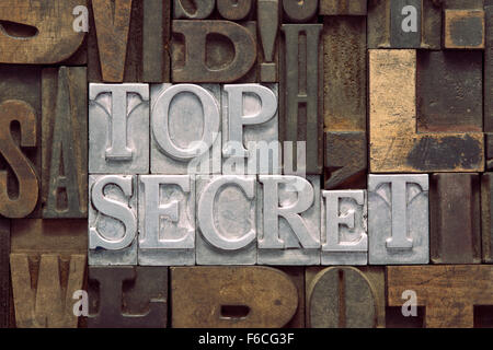 top secret phrase made from metallic letterpress blocks in mixed wooden letters Stock Photo