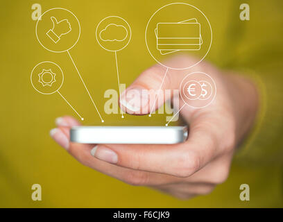 Hand holding smartphone with media icons and symbols concept Stock Photo