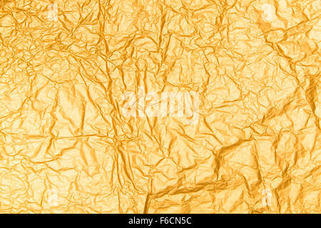 Texture of crumpled packaging gold paper background, creased and folded Stock Photo