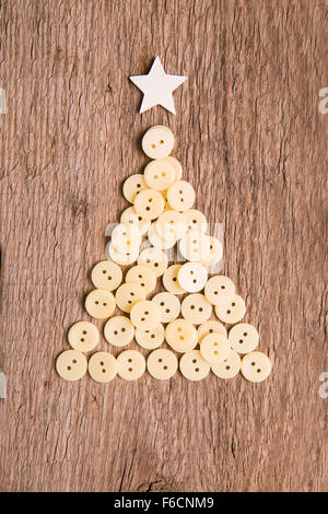 White buttons as decorative Christmas tree on wooden vintage background Stock Photo