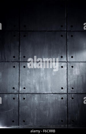 Gray concrete wall with big blocks in contrast dark colors Stock Photo