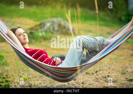 Young woman resting in hammock. Stock Photo