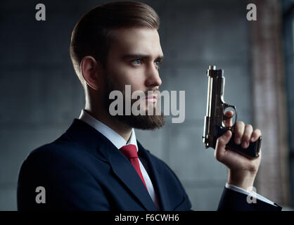 Danger man with gun looking aside portrait. Stock Photo