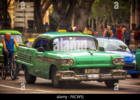 green vintage car in the street scene, old American road cruiser on the streets of Havana, taxi, public transport, La Habana, Stock Photo