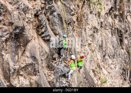 Banos, Ecuador - 30 November 2014: Basalt Challenge Of Tungurahua, Group Of Courageous Climbers Climbing A Rock Wall Stock Photo