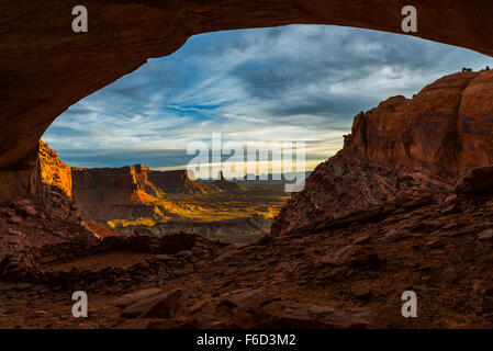 Beautiful golden sunset light falling down the canyon, view from false kiva Canyonlands National Park near Moab Utah United Stat Stock Photo