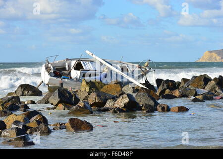 A Yacht being ship wrecked on the rocks on the beach at San Diego ...