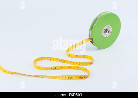 Green measuring tape for long distance measurement on white background Stock Photo