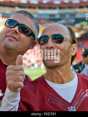 Academy of Country Music Award-winning artist Lee Greenwood, right, gives a 'thumbs-up' as he poses for a selfie with an unidentified fan prior to the New Orleans Saints playing the Washington Redskins at FedEx Field in Landover, Maryland on Sunday, November 15, 2015. Credit: Ron Sachs/CNP - NO WIRE SERVICE - Stock Photo