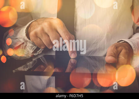 Businessman working on tablet computer, retro toned image, bokeh light, selective focus Stock Photo