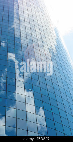 Modern glass skycrapers background with sky and clouds reflection. Stock Photo