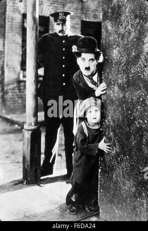 RELEASE DATE: February 6, 1921   MOVIE TITLE: The Kid   STUDIO: First National Pictures   PLOT: The Tramp cares for an abandoned child, but events put that relationship in jeopardy.   PICTURED: CHARLES CHAPLIN as A Tramp, JACKIE COOGAN as The Kid, TOM WILSON. Stock Photo