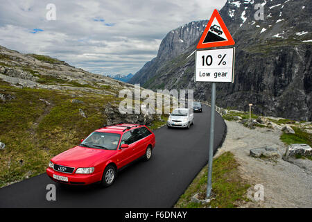 Cars passing a road sign warning of a steep road grade on the Trollstigen National Tourist Route, Møre og Romsdal, Norway Stock Photo