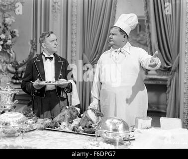 RELEASE DATE: December 6, 1944. MOVIE TITLE: Nothing But Trouble. STUDIO: Metro-Goldwyn-Mayer (MGM). PLOT: Working as chef and butler, the boys wreck a fancy dinner party and, in the process, accidently foil a plot, by enemy agents, to poison a young exiled king. PICTURED: STAN LAUREL as Stan and OLIVER HARDY as Ollie. Stock Photo