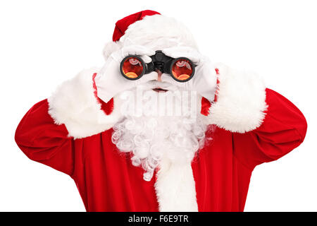 Studio shot of Santa Claus looking through binoculars isolated on white background Stock Photo