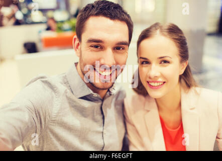 happy couple taking selfie in mall or office Stock Photo