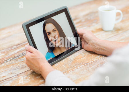 senior woman with photo on tablet pc at home Stock Photo