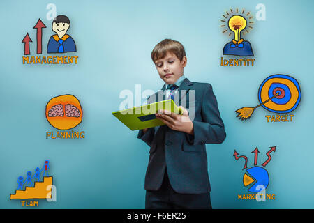 Teen boy businessman enthusiastically working on the tablet coll Stock Photo
