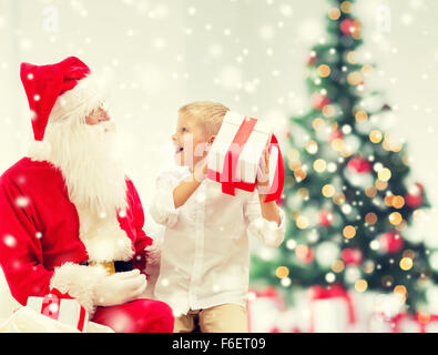 smiling little boy with santa claus and gifts Stock Photo