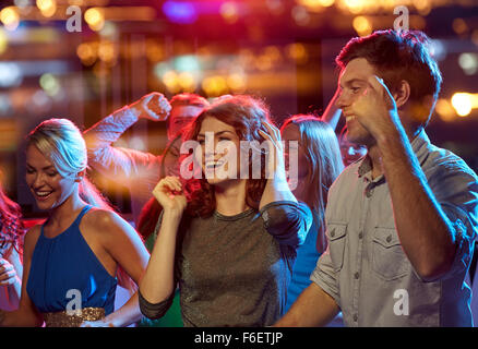 group of happy friends dancing in night club Stock Photo