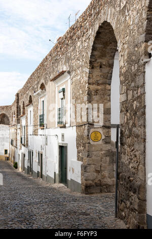 houses build in the old city wall in evora alentejo Portugal Stock Photo