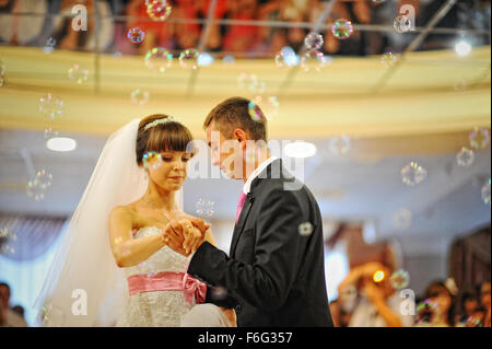 bride and groom dancing in the restaurant on bubbles Stock Photo