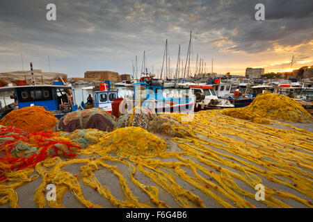 Fishing boats and fishing nets in the old harbour of Heraklion in Crete, Greece Stock Photo