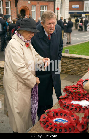 Elderly couple inspecting the wreath's laid at the War memorial during the 2015 Remembrance Day commemoration service in Surrey Stock Photo