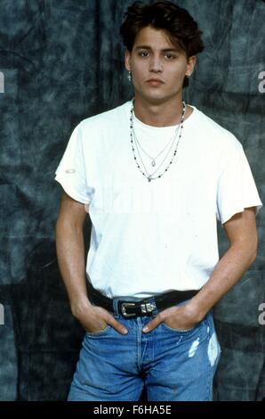 1989, Film Title: 21 JUMP STREET, Pictured: 1989, CLOTHING, JOHNNY DEPP, JEANS, TEE SHIRT, REBEL, TOUGH GUY, T-SHIRT - WHITE, CHAINS, CRUCIFIX, TORN, RIPPED, HANDS IN POCKETS, BELT, ADAMS APPLE, PORTRAIT. (Credit Image: SNAP) Stock Photo