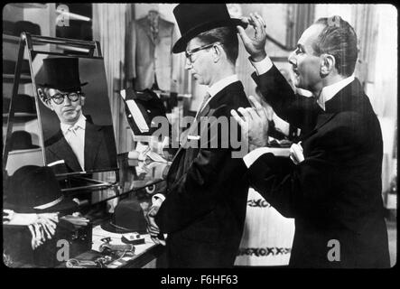 1953, Film Title: CALL ME MADAM, Director: WALTER LANG, Studio: FOX, Pictured: HAT, HIGH CLASS, DONALD O'CONNOR, TOP, DRESSING, TRYING, FITTING, GLASSES, SERVING, ATTENDING, MIRROR, REFLECTION, SHOP KEEPER, SHOP ASSISTANT, ARROGANT, POSH, WEALTHY, BOURGEOIS, CONDESCENDING. (Credit Image: SNAP) Stock Photo